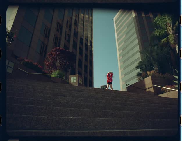 A woman flails her arms around as she dances outside