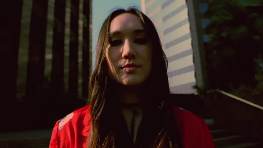 A woman is posing outside