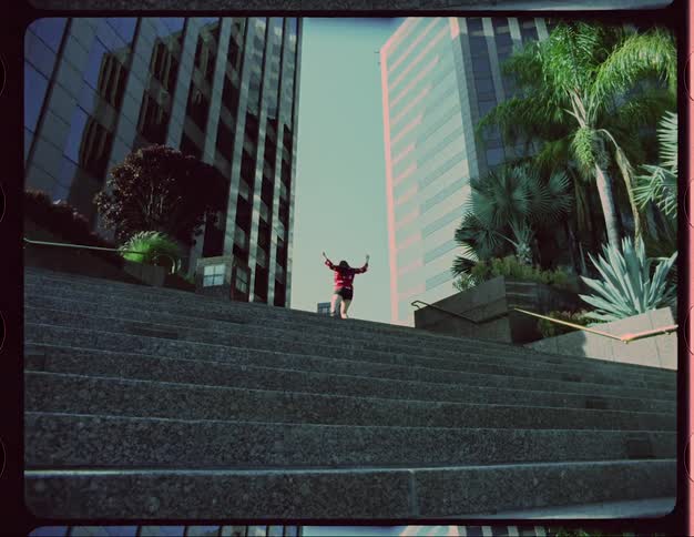 A woman is dancing in an urban city during spring