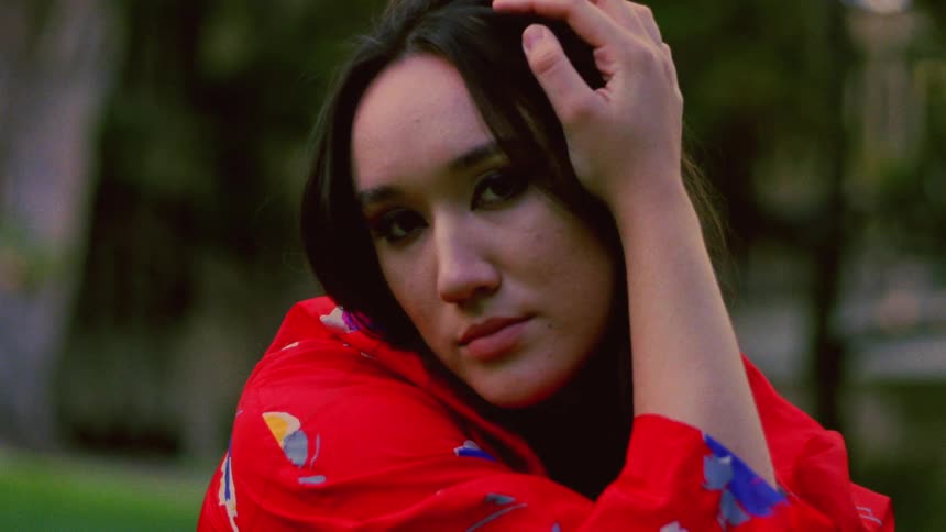 A woman is posing for the camera outdoors in spring