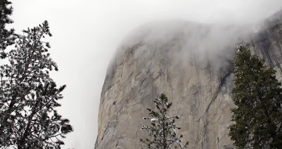 Clouds cover the top of this cliff