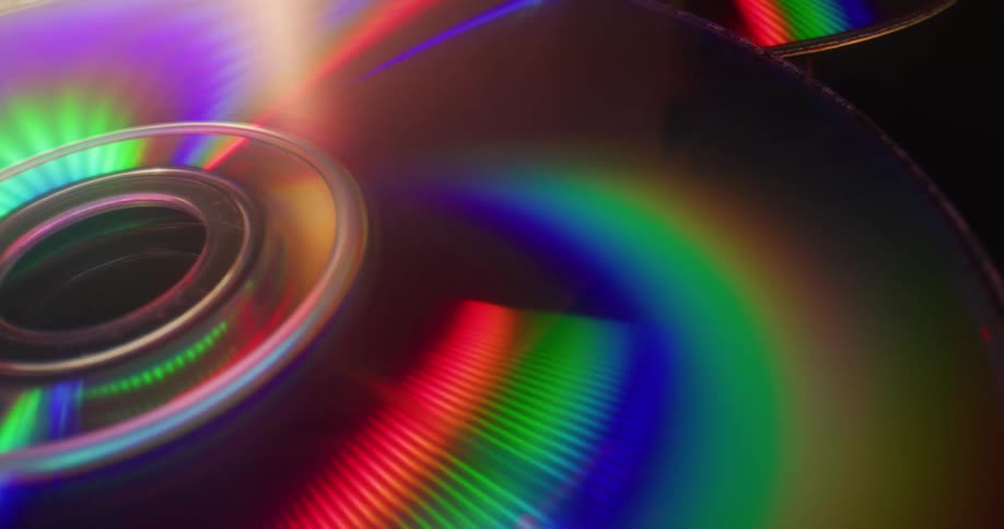 Cds reflect colorful light in the grooves