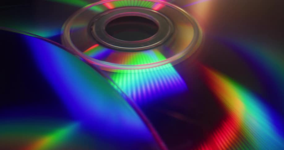 A rainbow of color moves across the surface of several discs