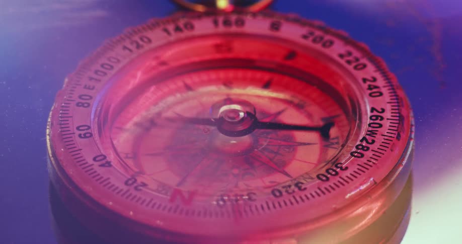 A compass hand moves while its underwater