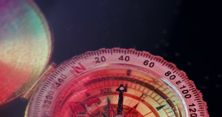 A pocket style compass floats in water