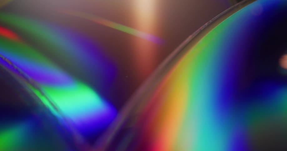 Bright light shines across iridescent surfaces of optical discs