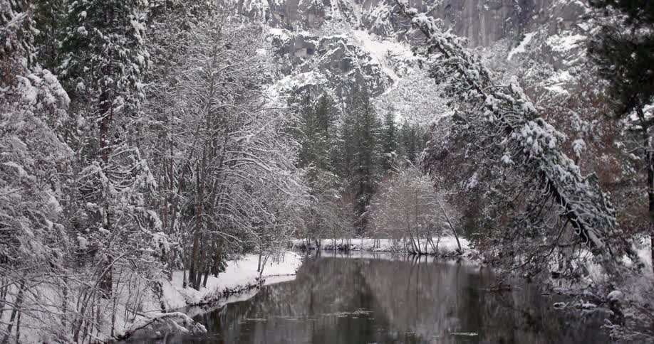 A river flows through a snow-covered mountain area