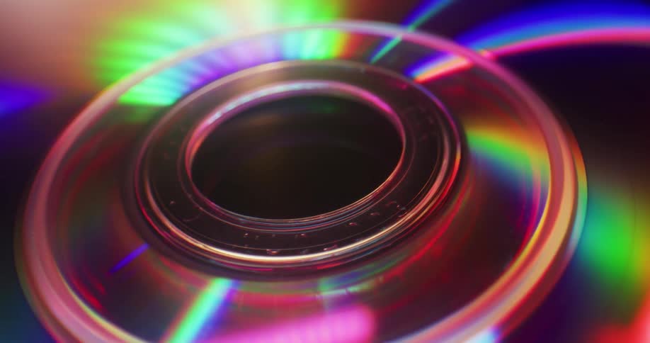 Bright light shines across iridescent surface of optical disks