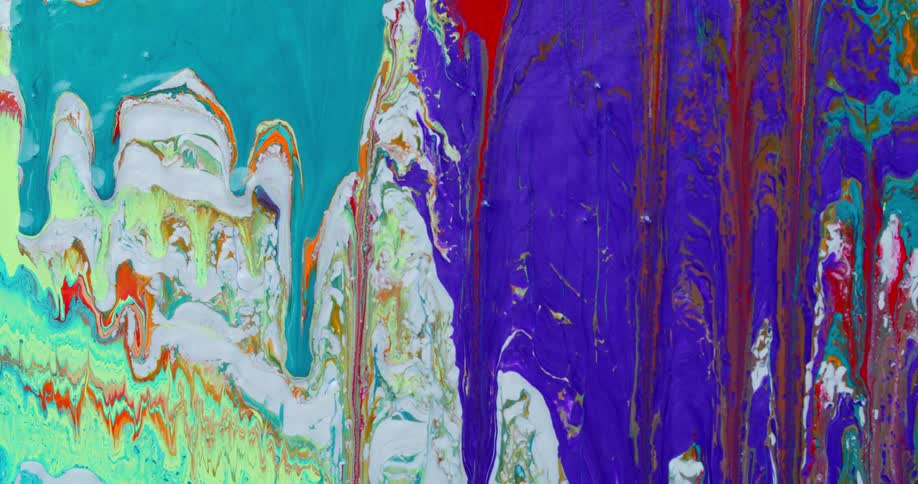 Streaks of colorful paint drip downward on an canvas to make a messy piece of art