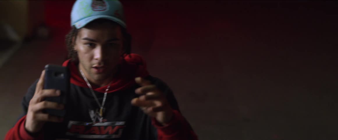 A young man holding up his phone filming and laughing suddenly drops the phone and puts his hands up