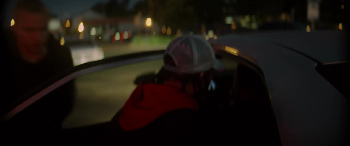 Two men try to steal an object from the backseat of a vehicle