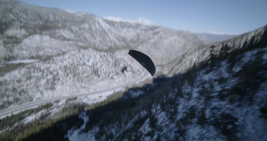 A person glides down the mountain