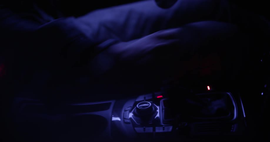 Person shifting in a car at night