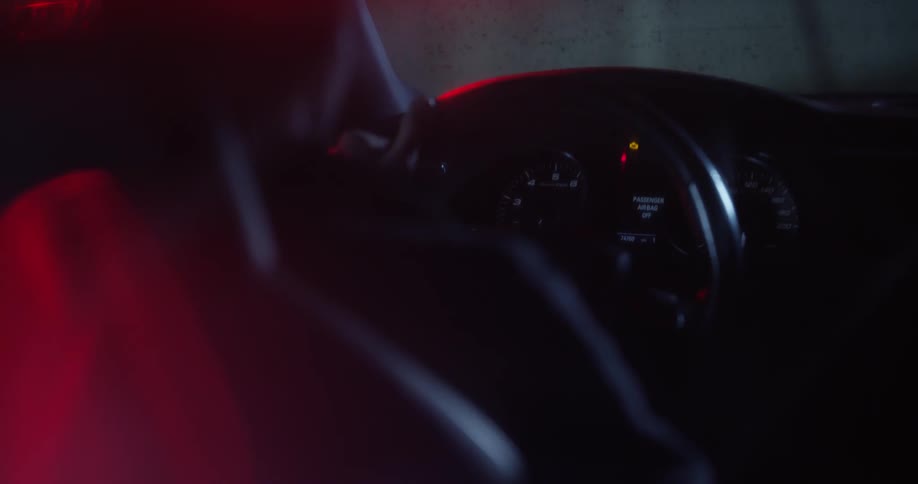 A person is sitting at the wheel of a car