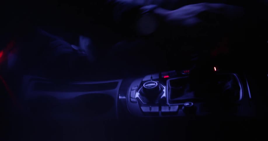 The console inside a car is briefly lit as a gear shift is moved