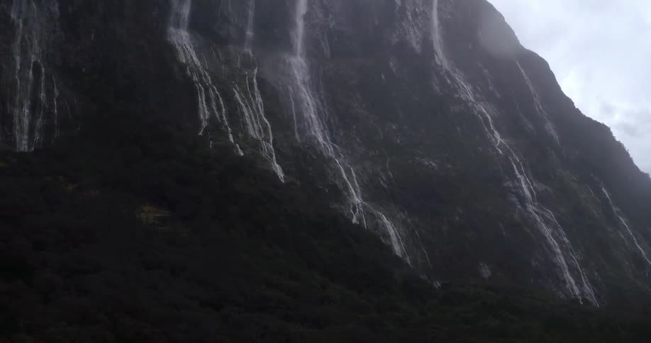 Rain falling as the camera pans up a rocky mountain