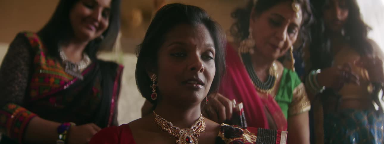 A group of indian women are dressed up for a special occasion
