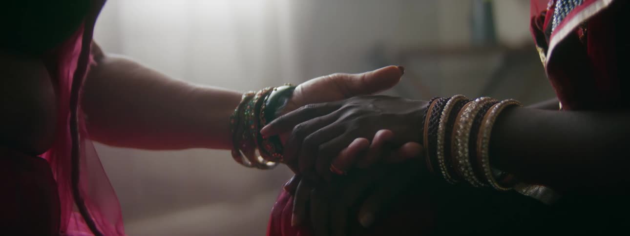 Two women touch each others hands