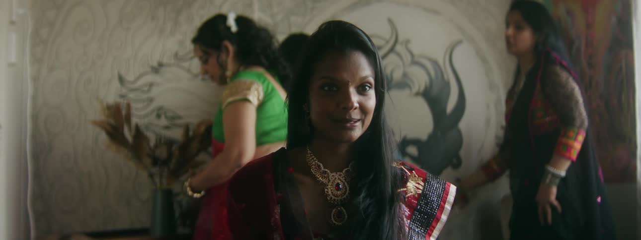 Group of women help a young hindi teenager to choose jewelry