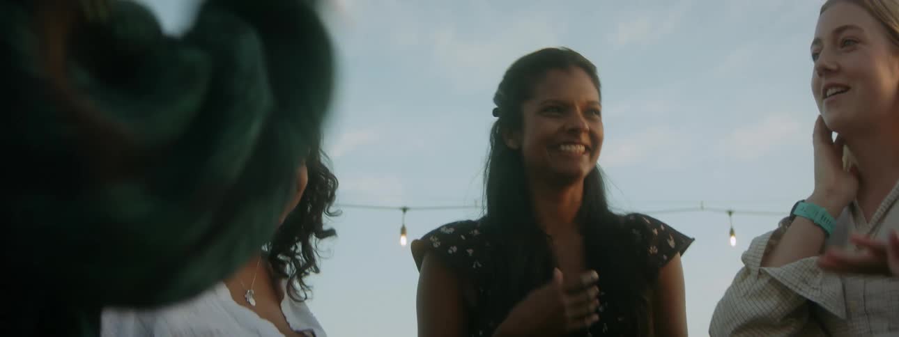 A group of female friends standing and talking outside