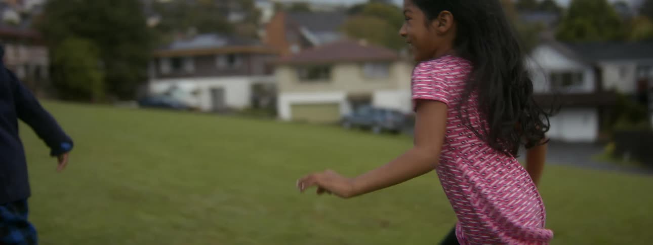 Two children running and playing outdoors