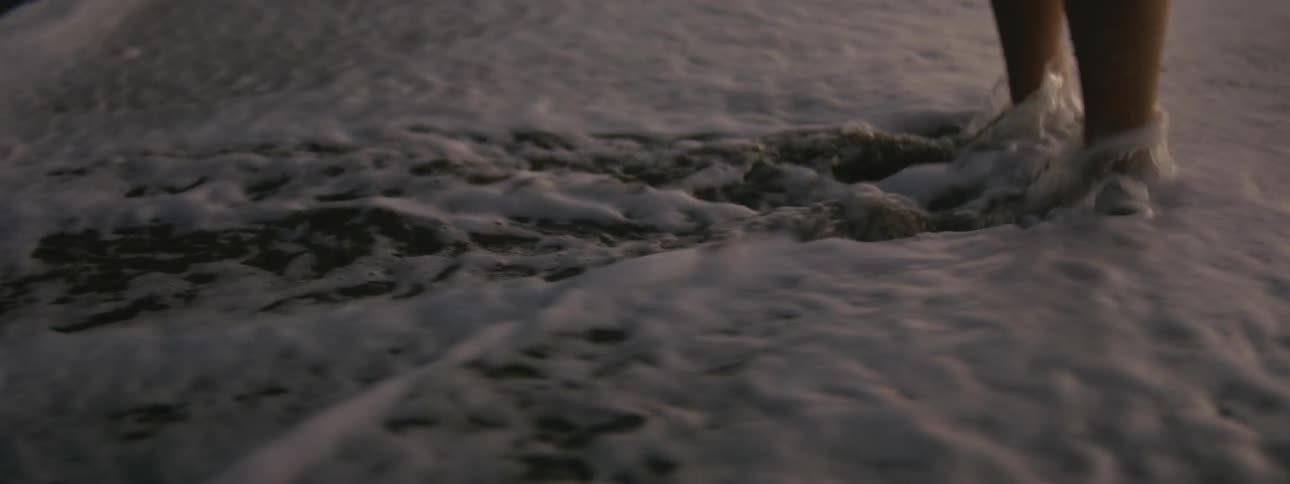 A person stands near the shore