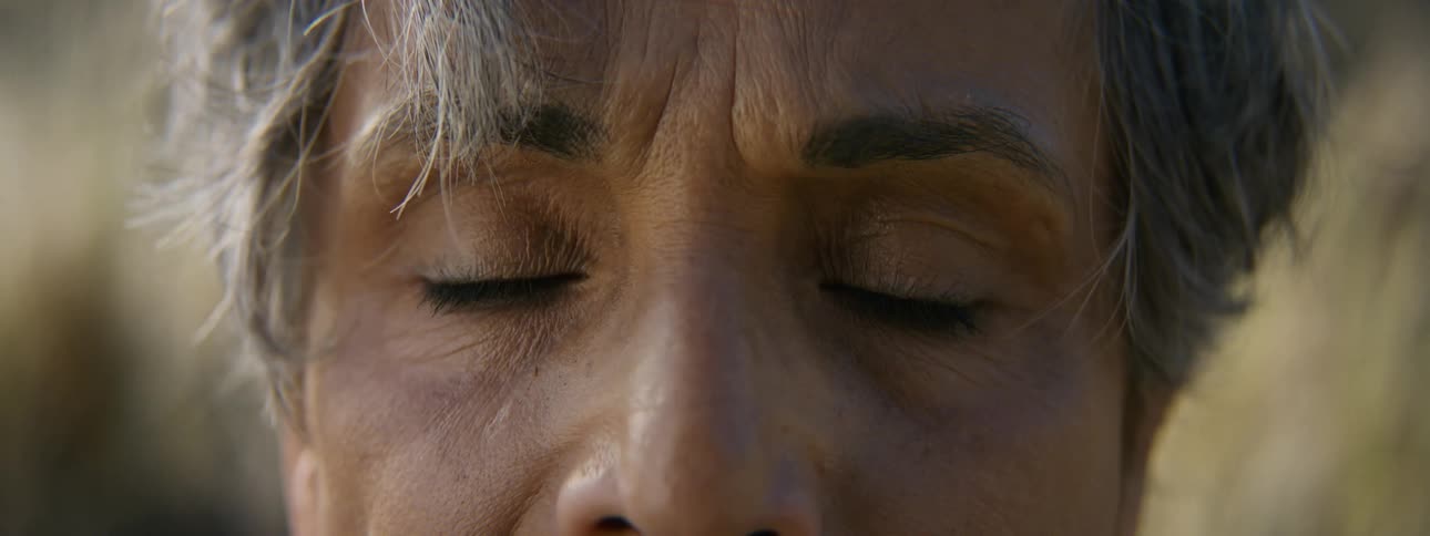 A woman closes her eyes as she meditates