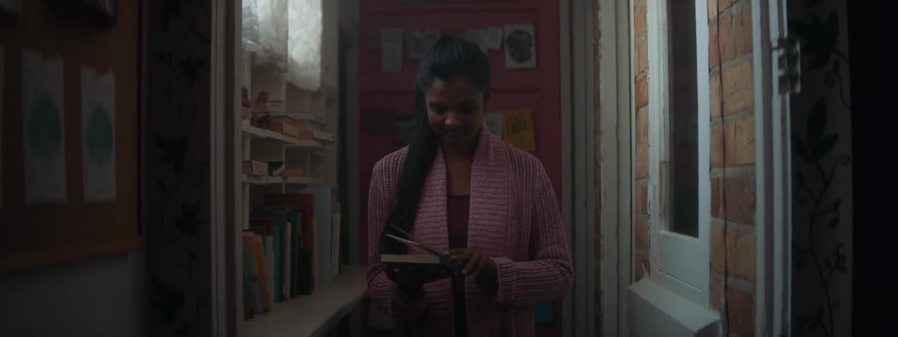 A woman is opening a book and reading it