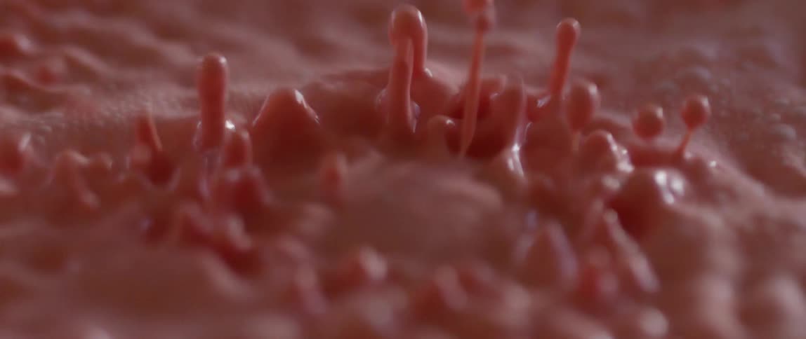 Red liquid undulating and bouncing