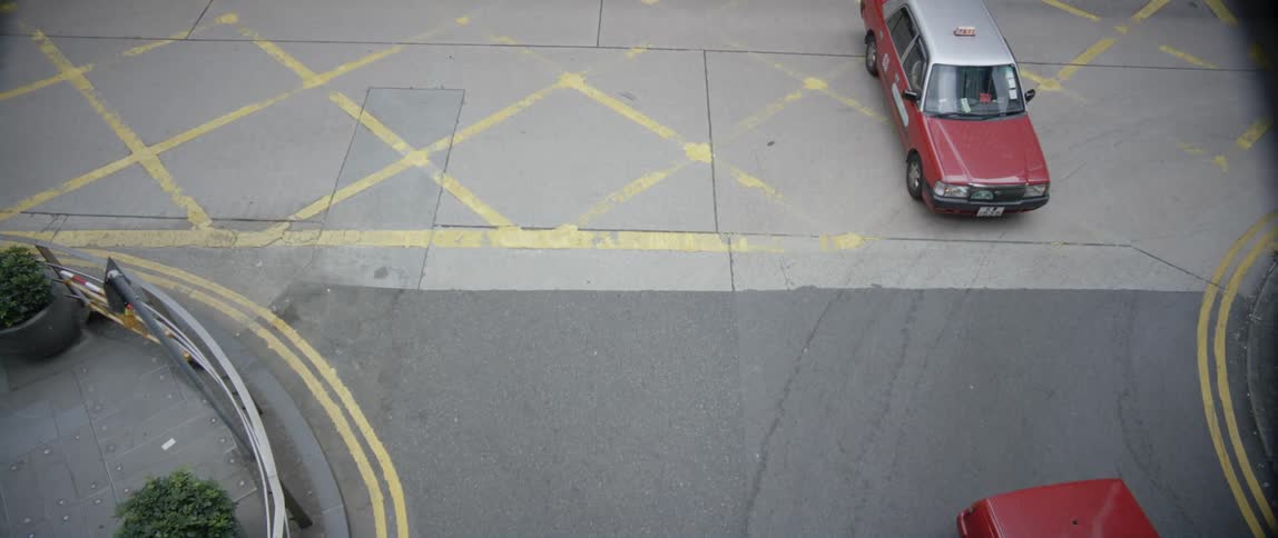 Cars drive through the intersection in the city