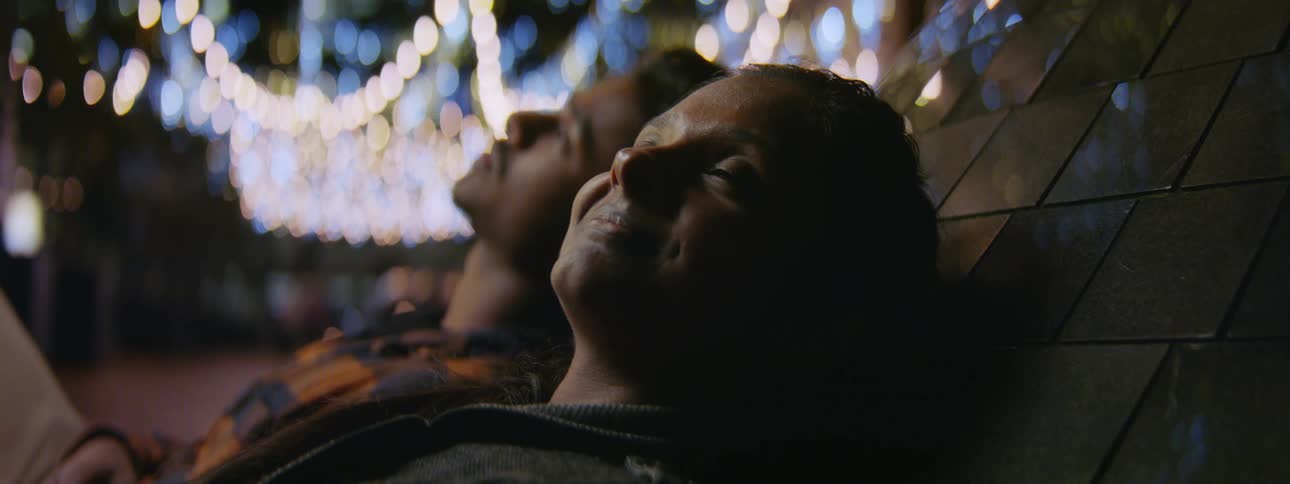 Man and woman are resting outdoors during the night