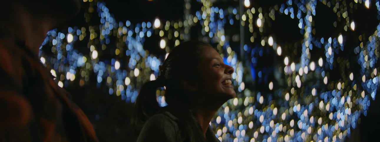 Woman and man are outdoors during the night time