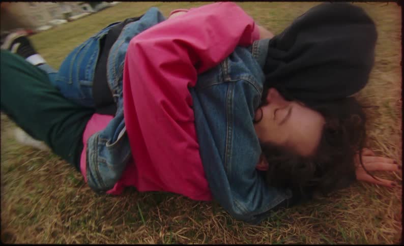 A woman runs at a man and leaps at him crying as they are reunited