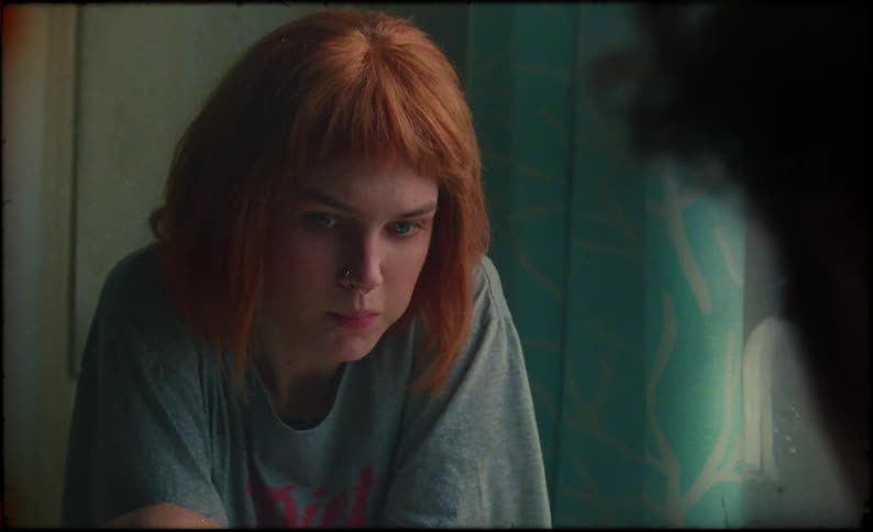 Redhead woman sitting at the table eating berries next to a man