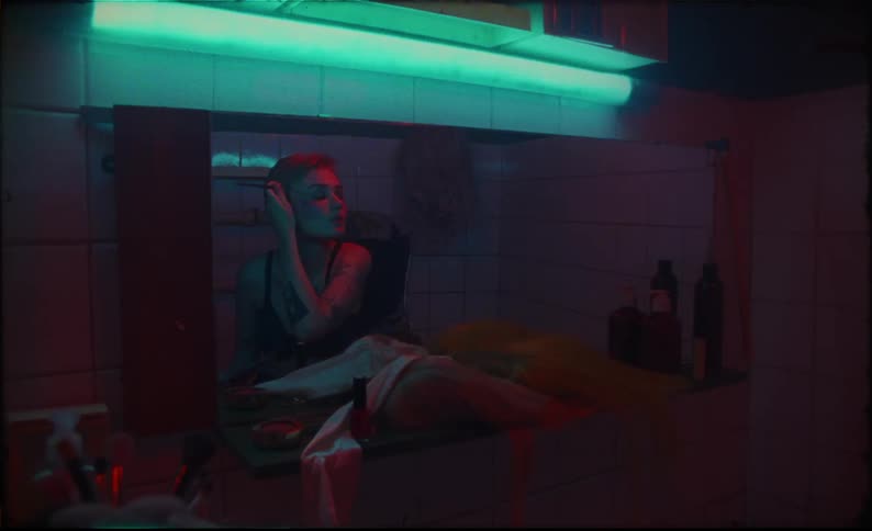 A woman putting on makeup in a room