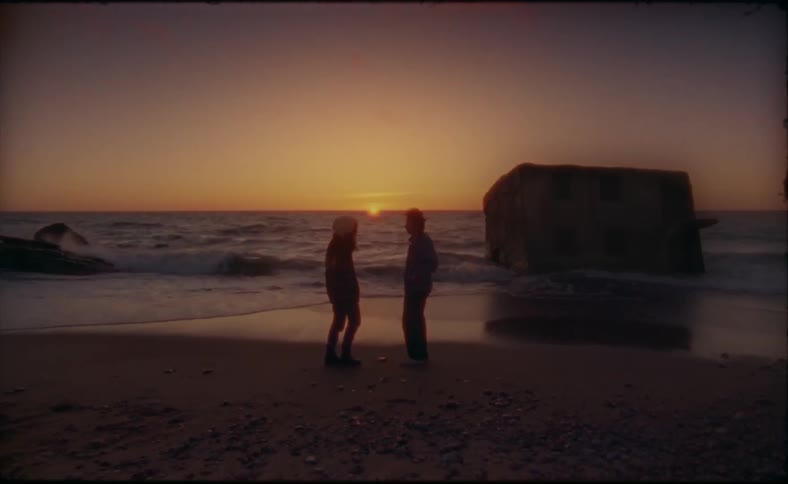 Two people hug on the beach
