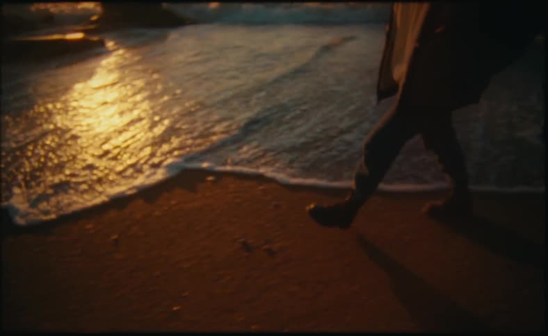 A view of a person walking on the beach