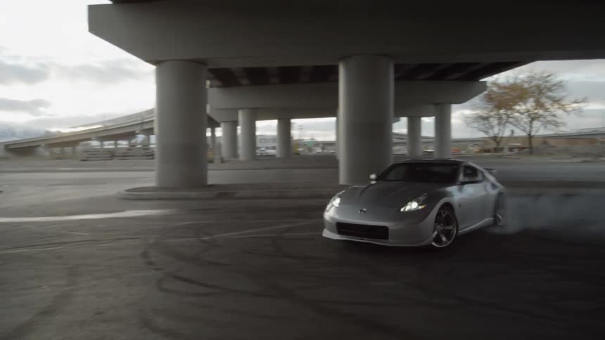 Car  spinning out in circles under a bridge