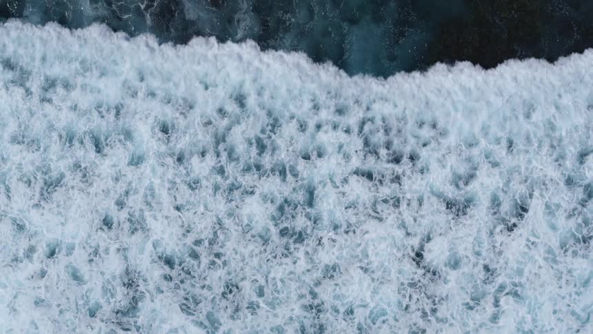The view is of the ocean waves in the middle of the day time