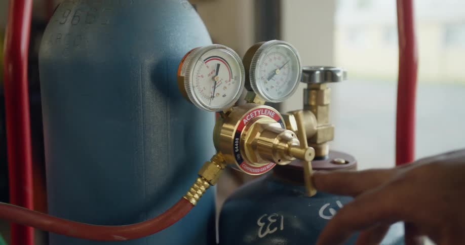 A person opening a valve