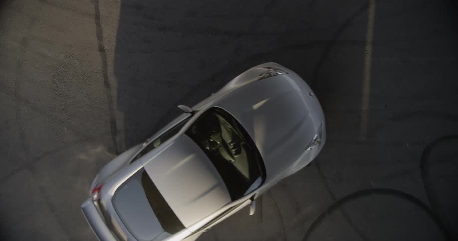 A car is doing donuts in a parking lot