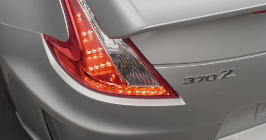 A silver car with red taillights