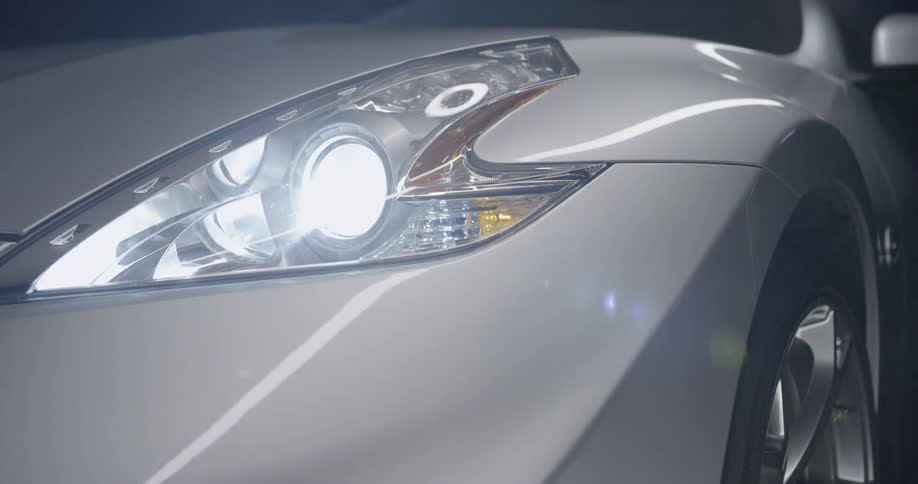 A white car with bright headlights