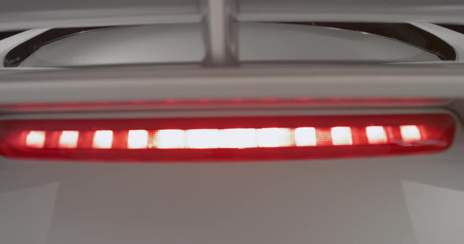 The interior of a sports car is seen just before the hatchback is closed