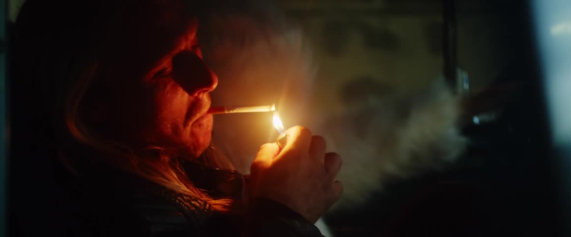 Man is smoking a cigarette in a vehicle