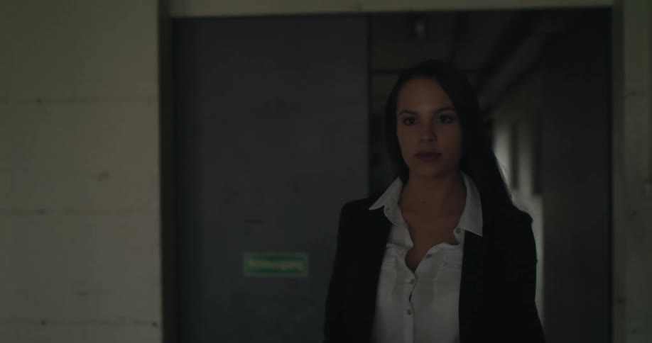 A woman walks into an industrial building