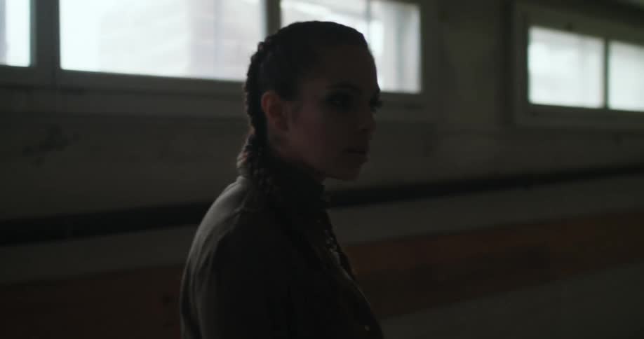 A woman is walking through a dark room