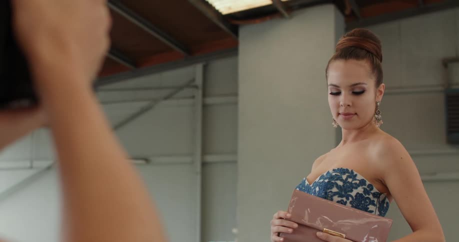A woman is wearing a dress at a photo shoot