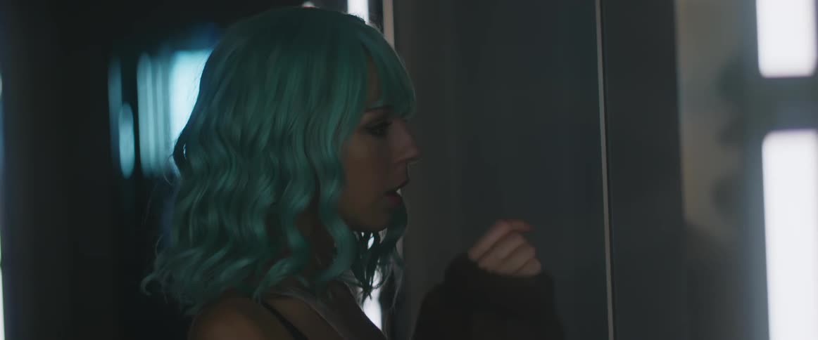 A woman is knocking on a door in a building
