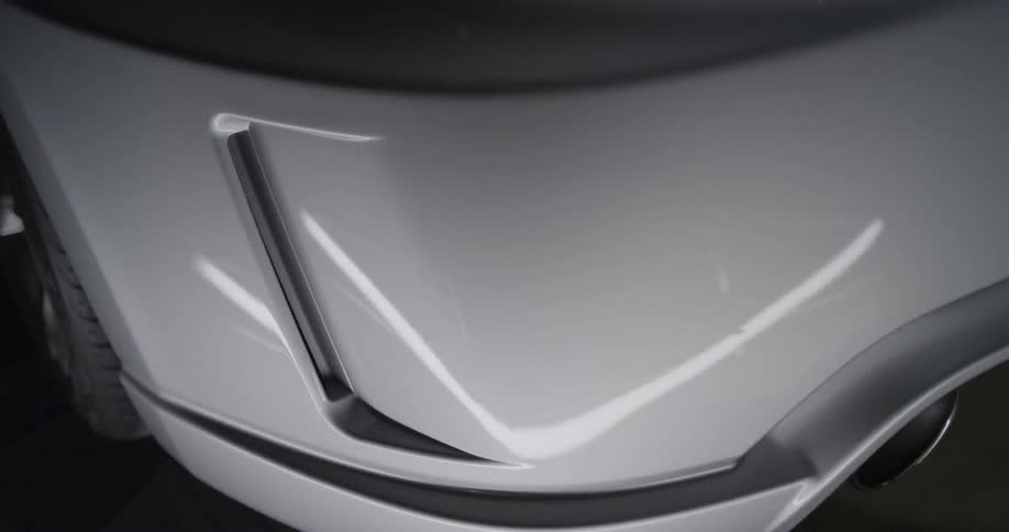 A white car in a dim room